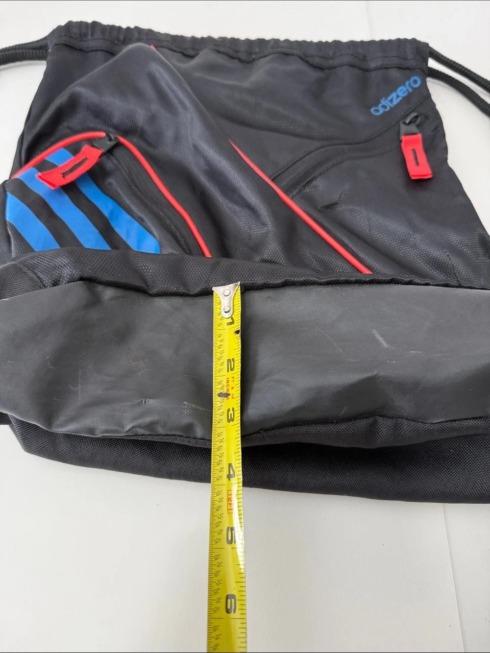 adidas Black Drawstring Backpack with Blue Stripes and Red Accents